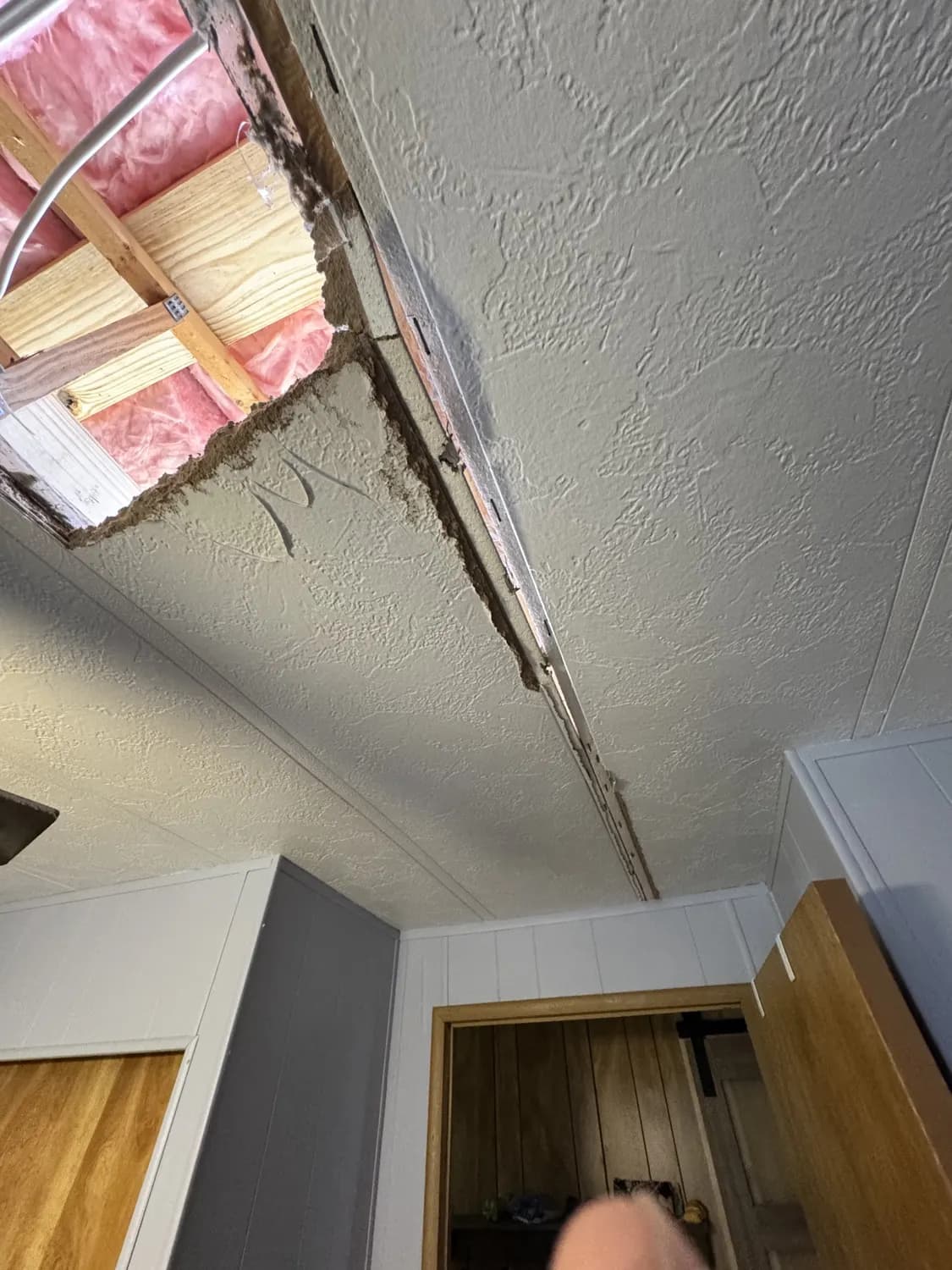 Sunken, cracked ceiling inside the mobile home before the rebuild