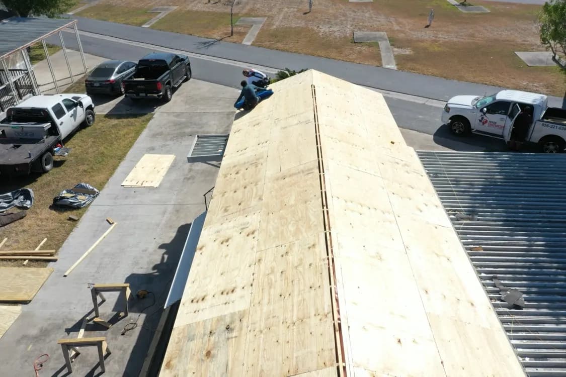 New roof decking installed over the rebuilt framing